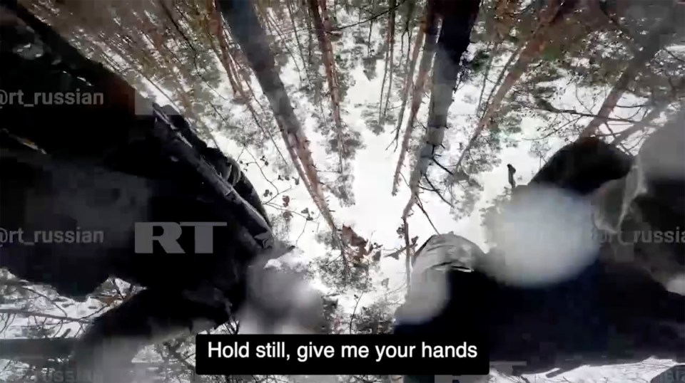 A British ex-soldier surrendering to Russian forces in a snowy forest.