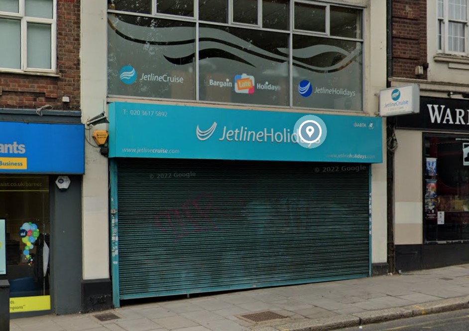 Jetline Holidays storefront with closed roll-up door.