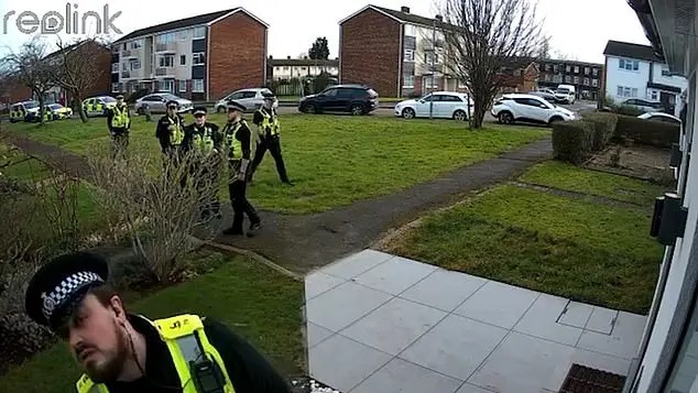A man is arrested by six police officers.