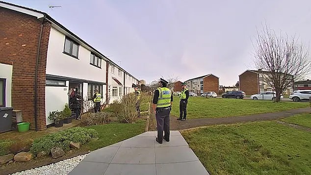 Police officers outside a residential building.