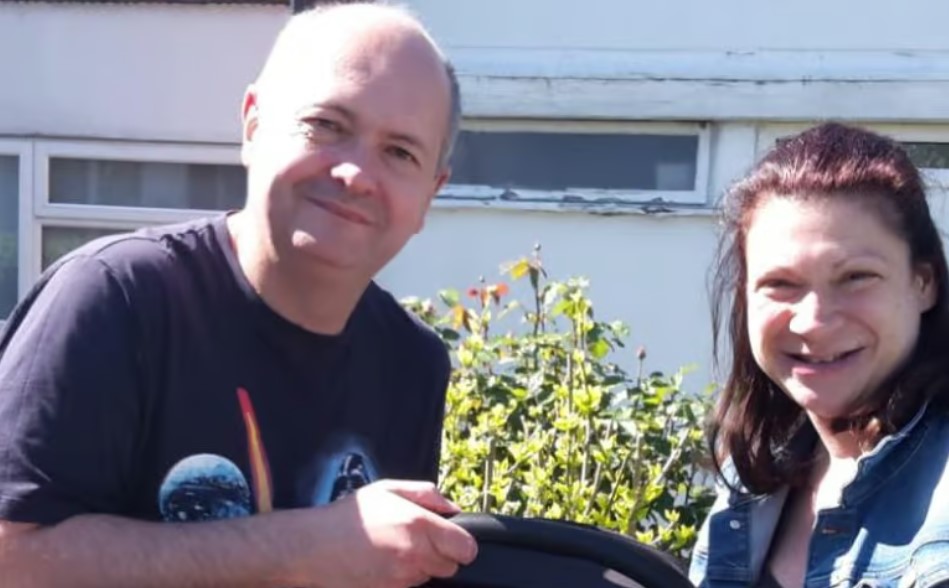 Photo of a man and woman standing outside a house.