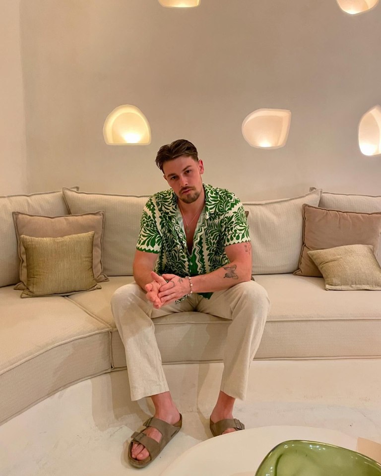 Andrew Le Page sitting on a couch.