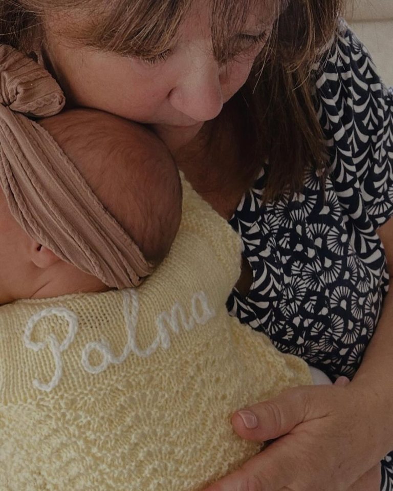 Grandmother holding baby Palma.