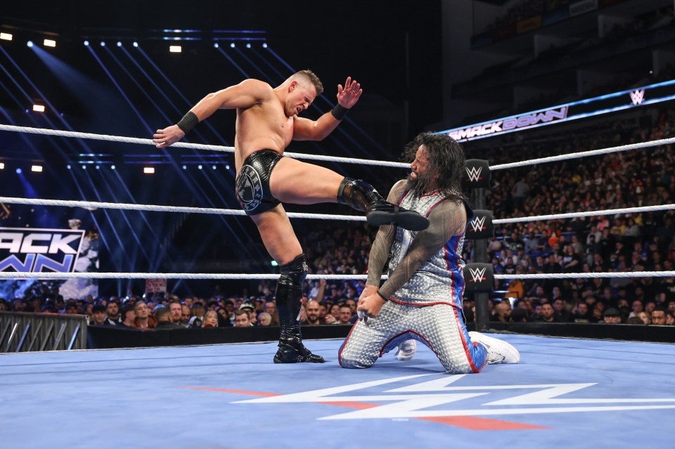 The Miz kicking Jimmy Uso during a SmackDown match.