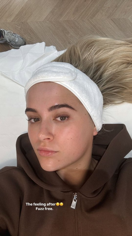 Woman with headband after facial treatment.