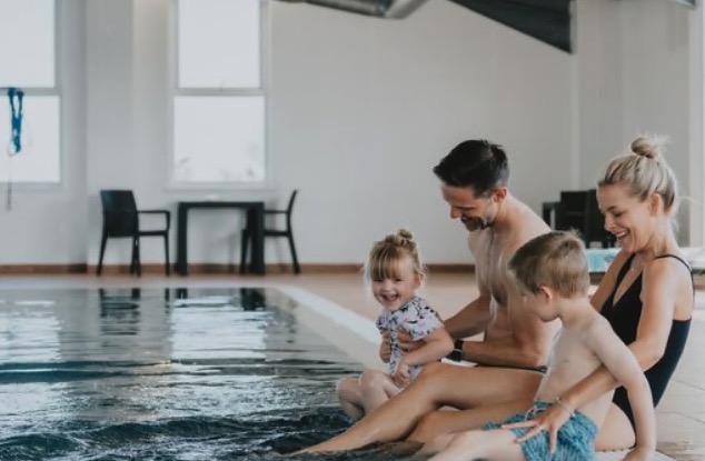 Family enjoying a pool at a holiday park.