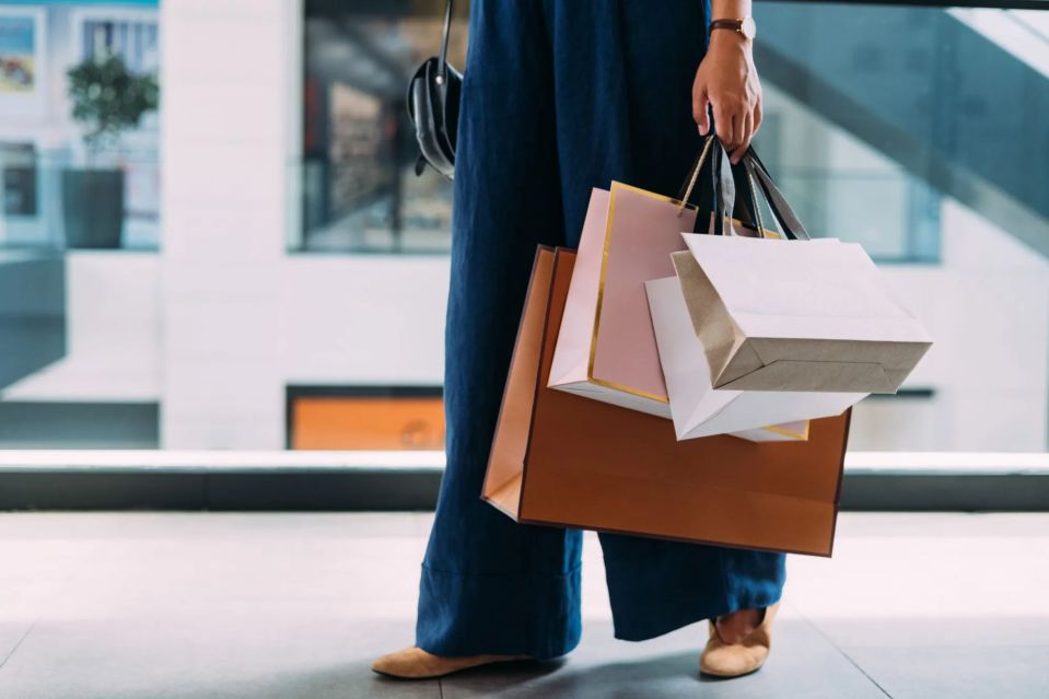 An image collage containing 1 images, Image 1 shows Woman carrying shopping bags in a mall
