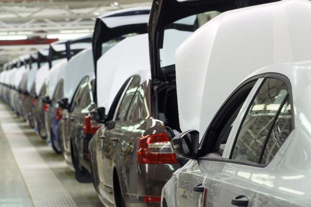 An image collage containing 1 images, Image 1 shows Row of Skoda cars with protective wrapping on their hoods in a factory