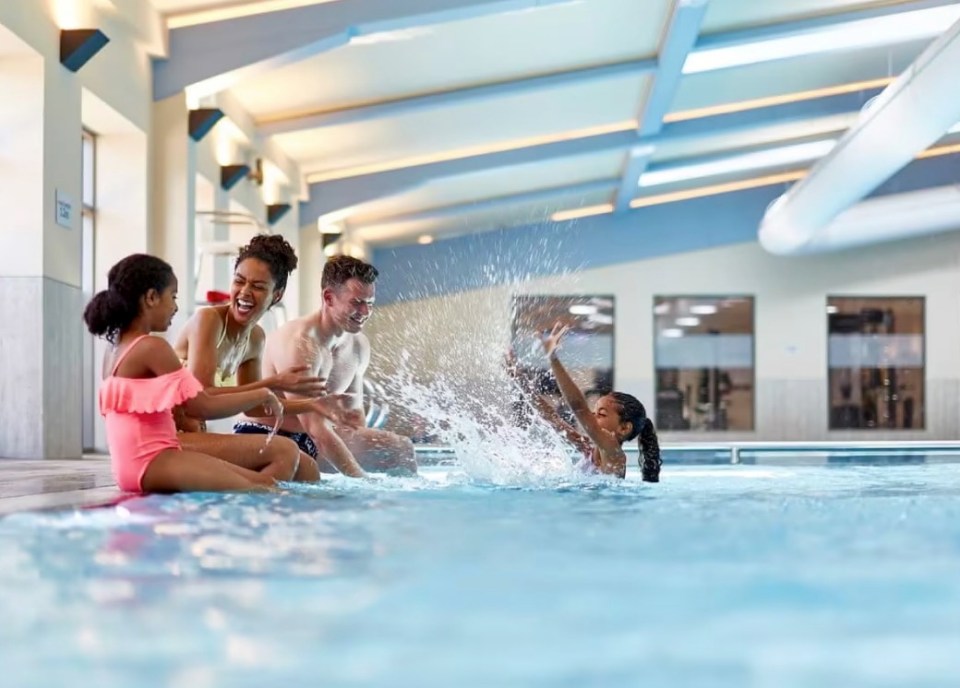 Family splashing in a resort pool.