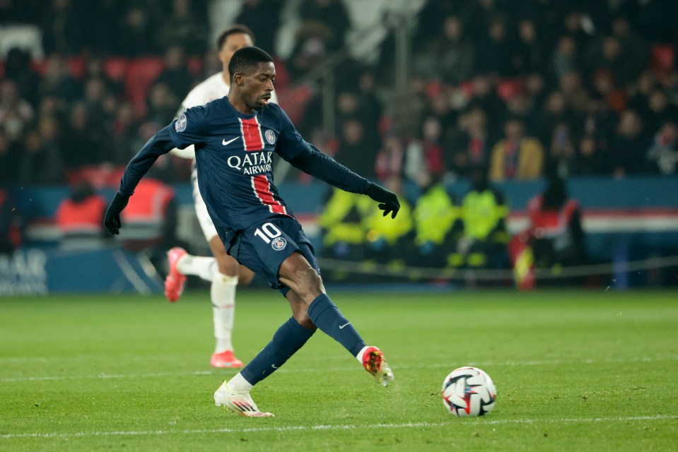 Ousmane Dembele of PSG kicking a soccer ball during a Ligue 1 match.