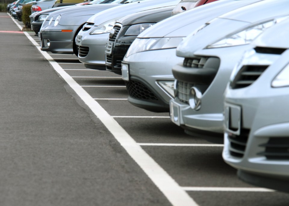 Cars parked in a row at an airport.