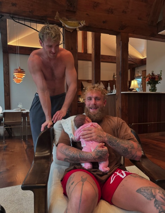 Two men holding a baby.