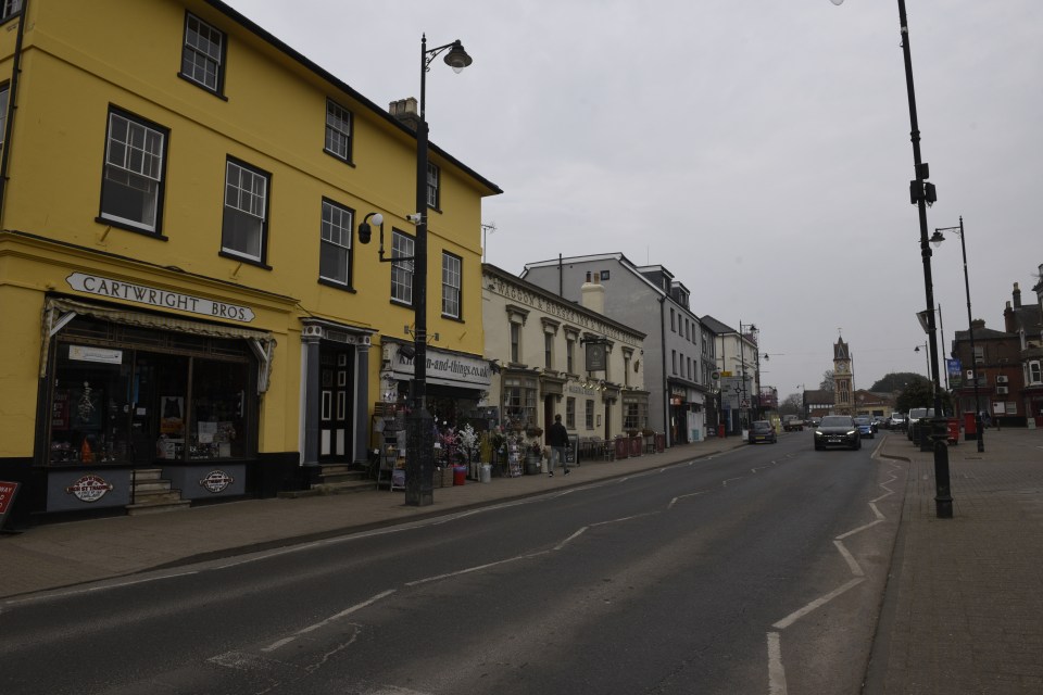 Street scene in Newmarket, Suffolk, showing shops and the Waggon & Horses pub.