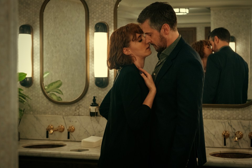Couple kissing in a bathroom.