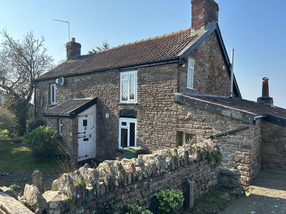 Stone cottage with a white door.