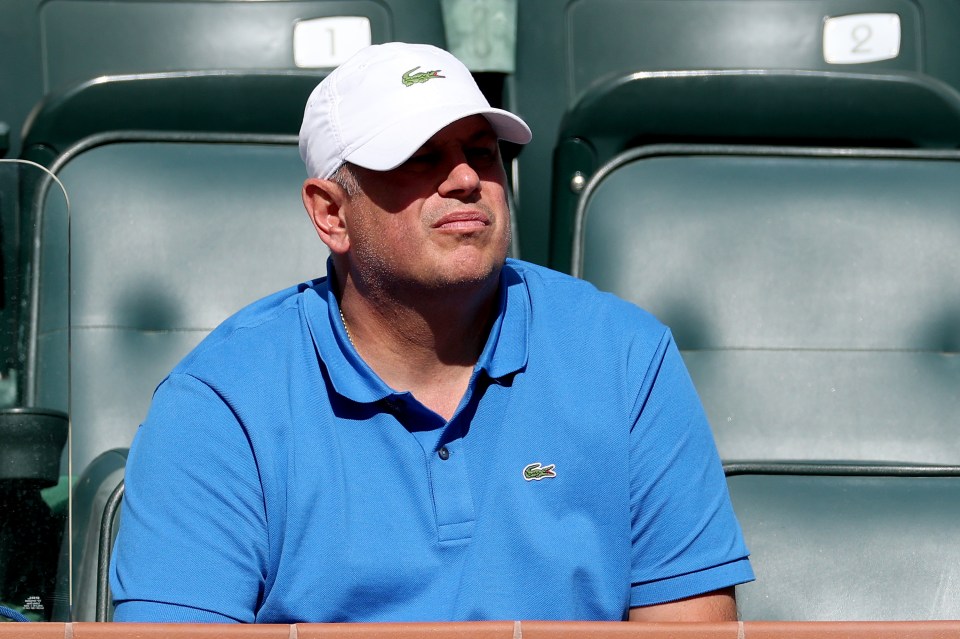 Vladimir Platenik watching a tennis match.