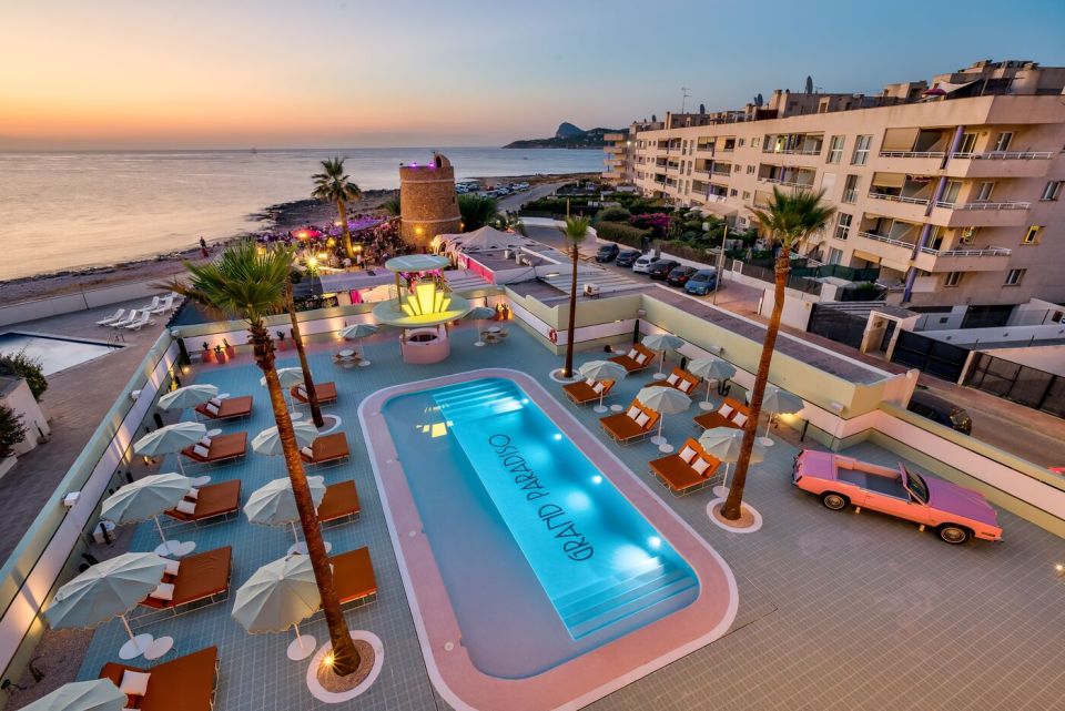 Aerial view of Grand Paradiso hotel pool and grounds at sunset.