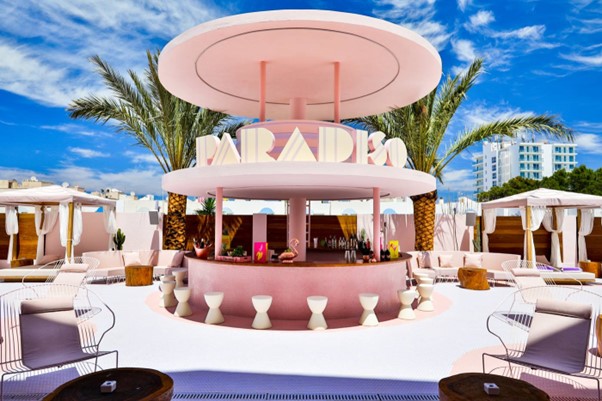 Pink Paradiso hotel bar with lounge seating.