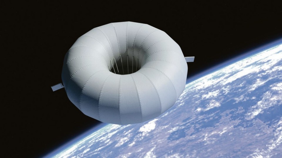 Illustration of a donut-shaped reentry vehicle in space above Earth.