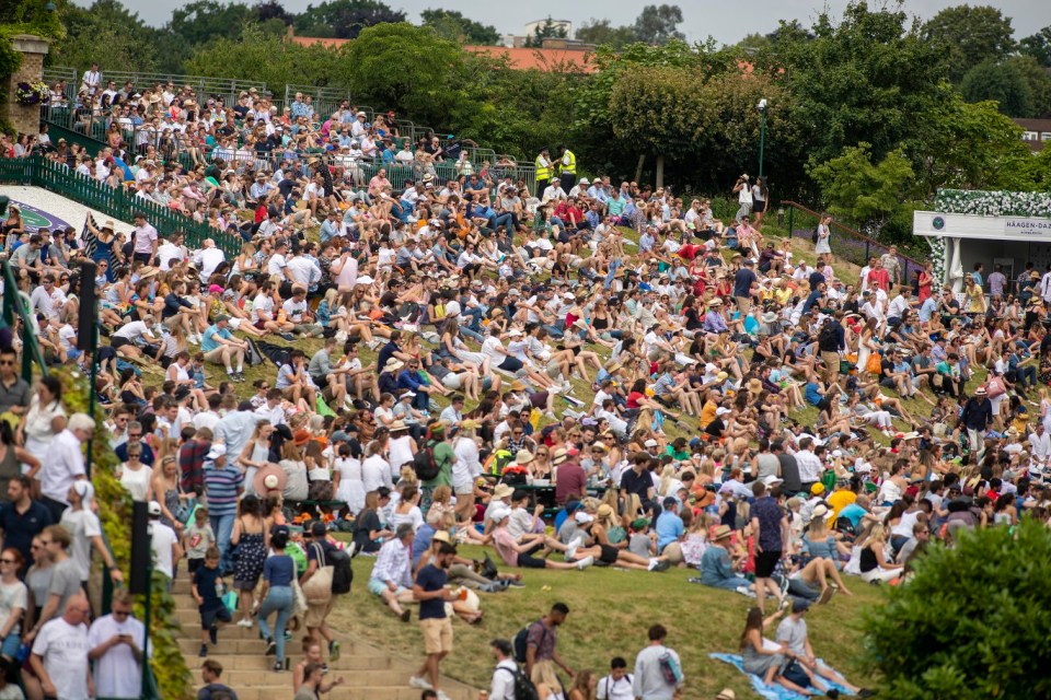LONDON, ENGLAND - July 06:  Fans watching a large outside screen on Henman Hill during the Wimbledon Lawn Tennis Championships at the All England Lawn Tennis and Croquet Club at Wimbledon on July 06, 2019 in London, England. (Photo by Tim Clayton/Corbis via Getty Images)