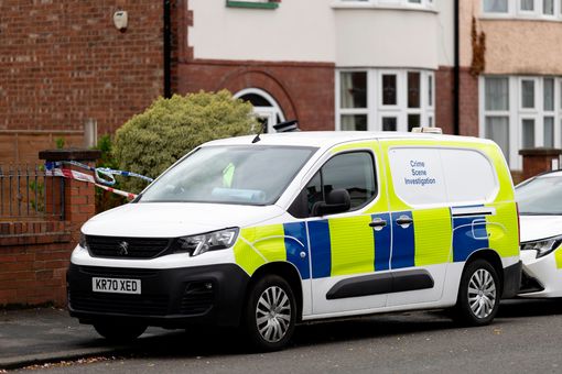 Crime scene investigation van outside a house.