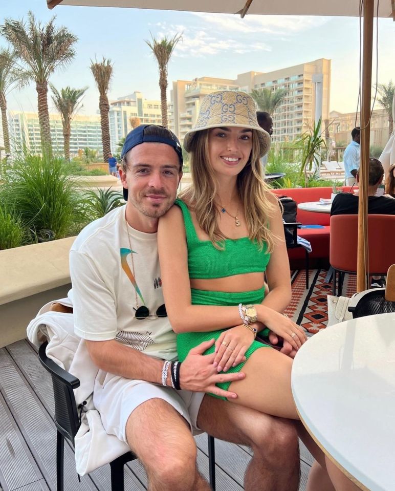 Couple sitting together outdoors.