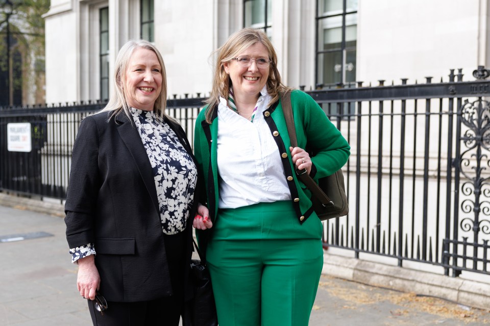 Two women, directors of For Women Scotland, stand outside the Supreme Court.