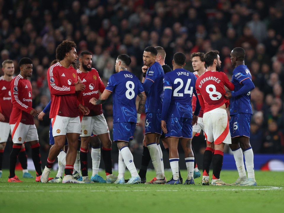 Referee separating Manchester United and Chelsea players after a fracas.