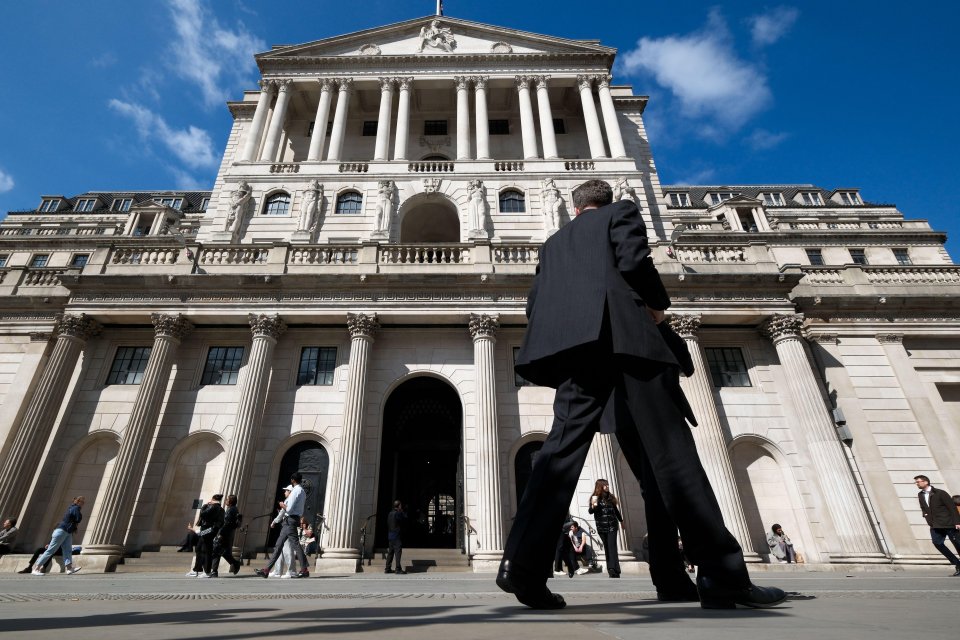 A man walks past the Bank of England.