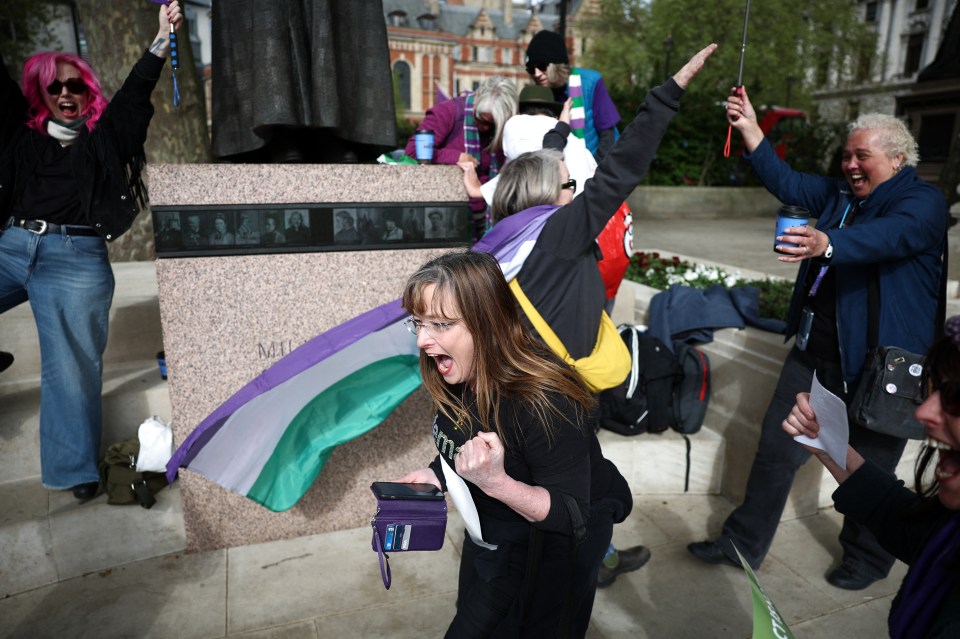 Activists celebrating a Supreme Court ruling on the legal definition of "woman."