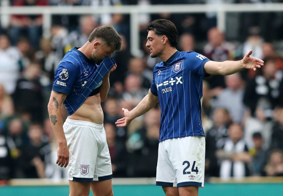 Two Ipswich Town soccer players react during a game.