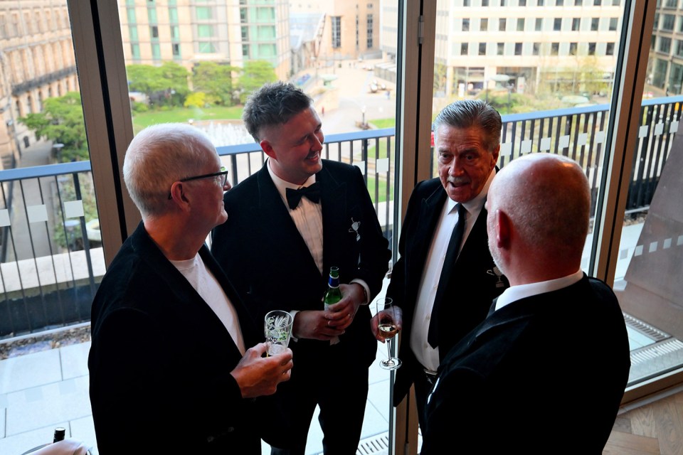 Four men in tuxedos at a snooker championship dinner.