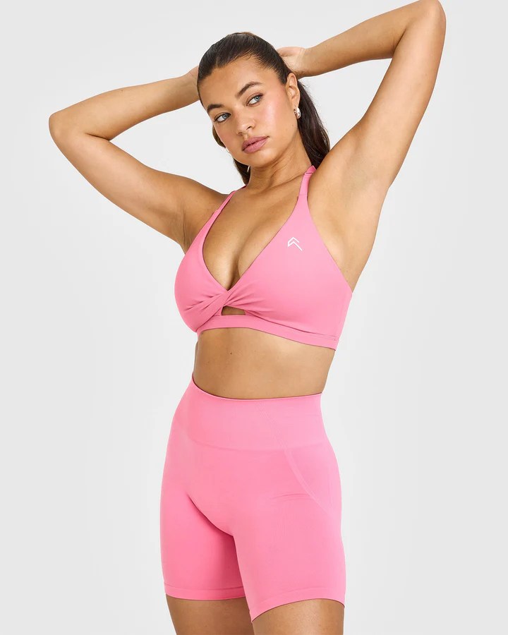 Woman in pink sports bra and shorts.