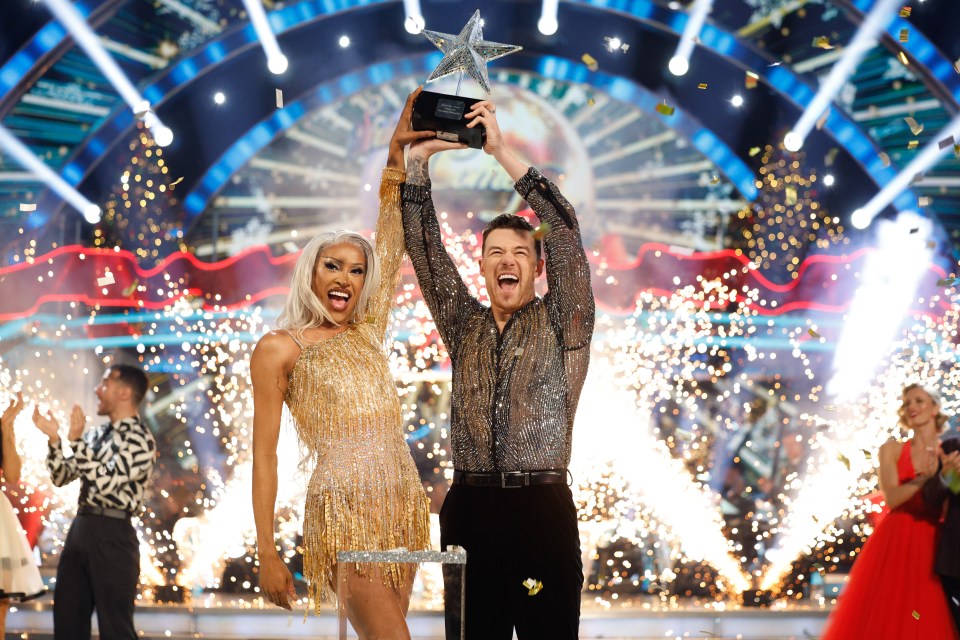 Tayce and Kai Widdrington holding a trophy after winning the Strictly Come Dancing Christmas Special.