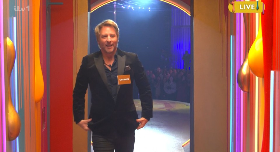 Chesney walking through a brightly lit doorway.