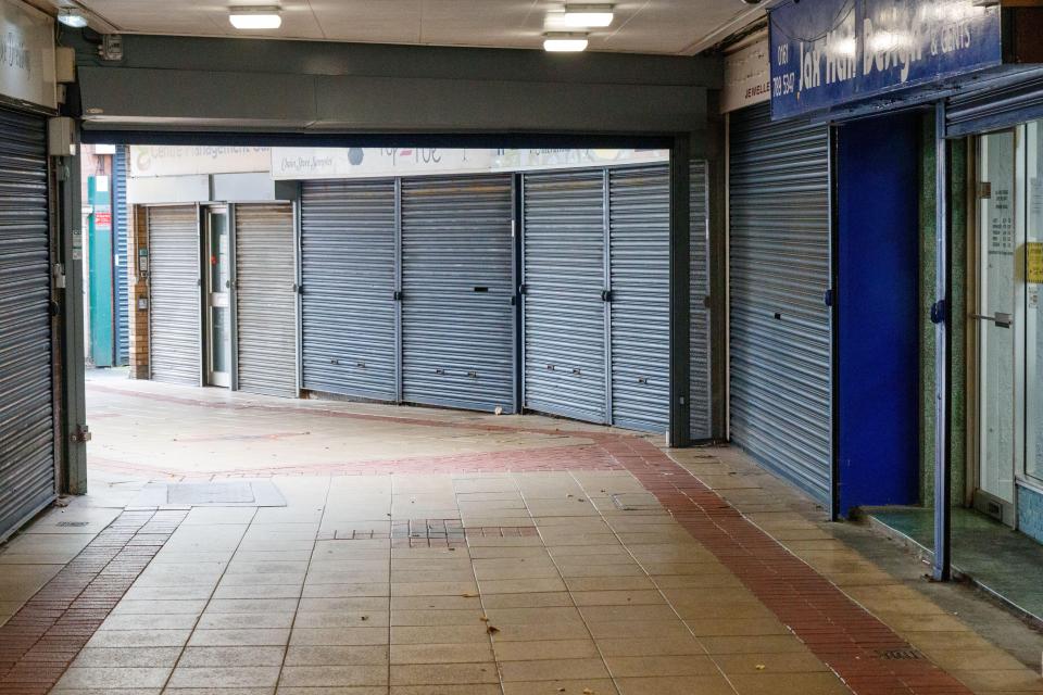 Empty shopping arcade with closed shops.