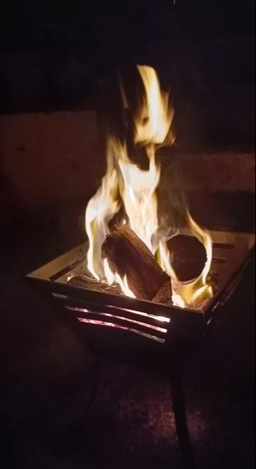 Fire burning in a metal fire pit.