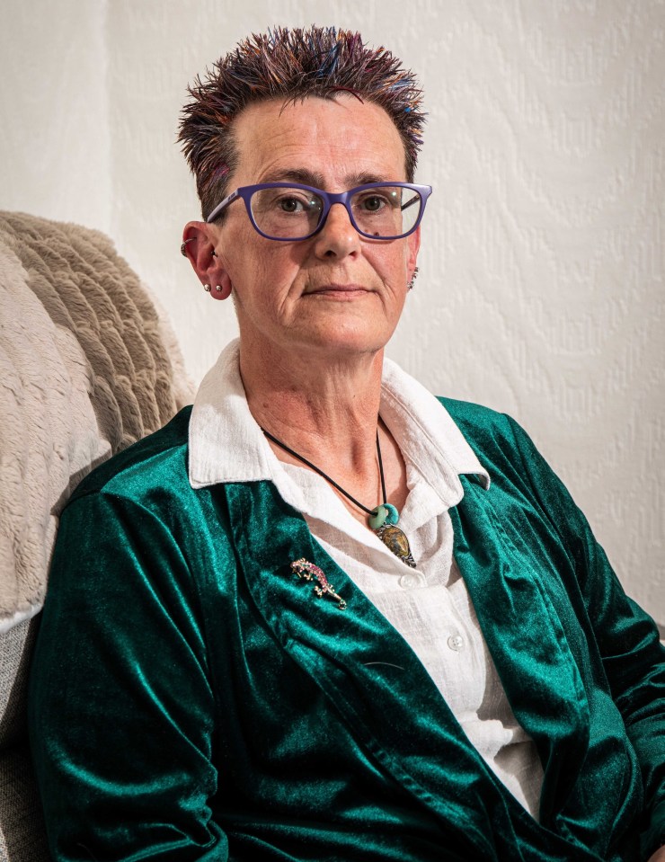 Portrait of a woman wearing glasses and a green velvet jacket.