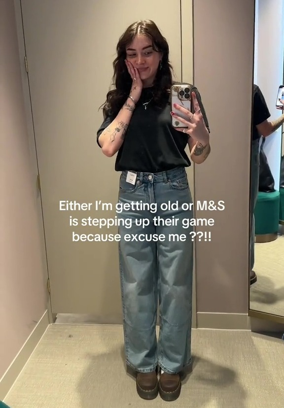 Woman in M&S jeans in a fitting room.