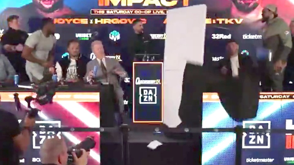 Boxing press conference with a large white board being thrown.