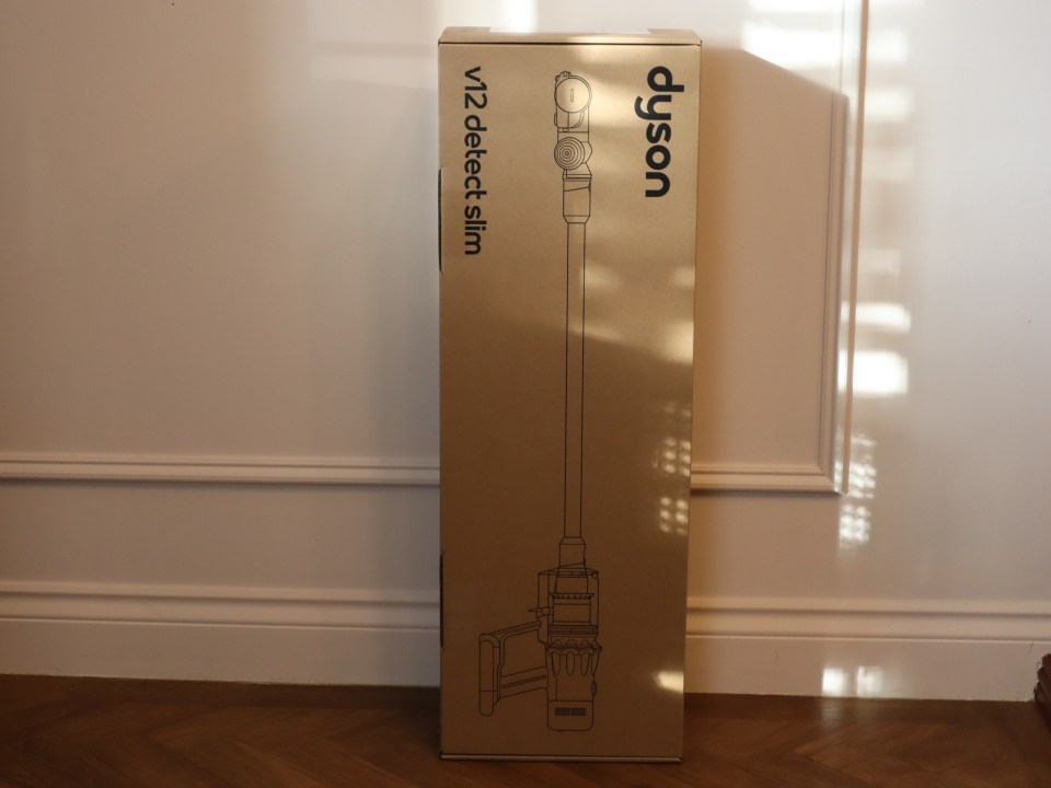 The Dyson V12 Detect Slim Absolute vacuum cleaner in its box.