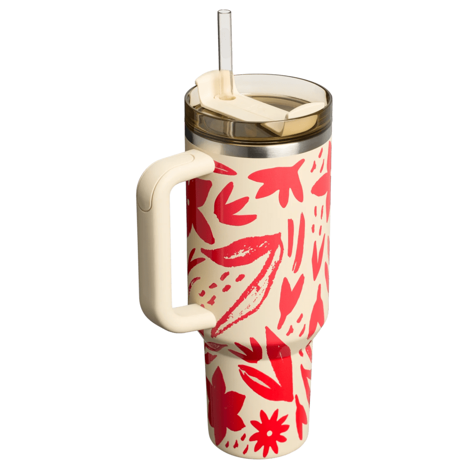 Floral-patterned tumbler with straw and handle.