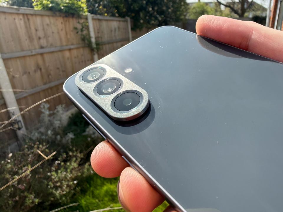 Close-up of a smartphone's triple-lens camera.