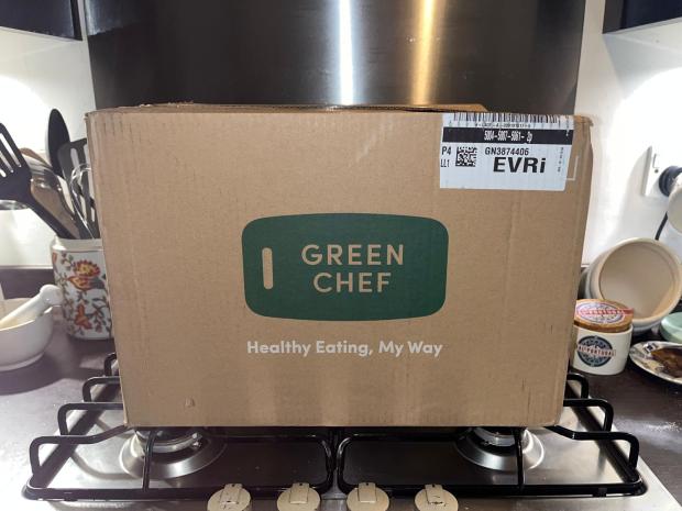 Green Chef delivery box on a stove.