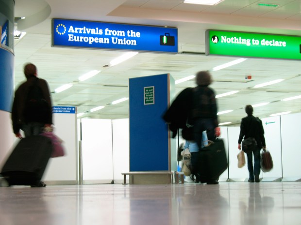 Passengers arriving at a UK airport customs.