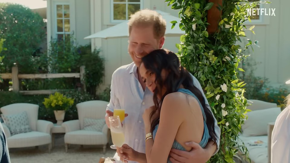 Meghan Markle and Prince Harry embracing outdoors.