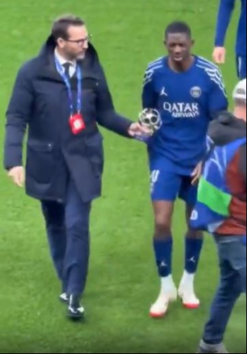 Ousmane Dembélé reluctantly accepts a Man of the Match award.