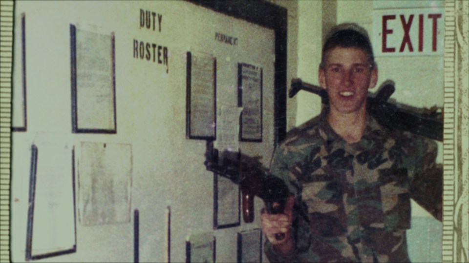 Timothy McVeigh in military uniform holding a rifle.
