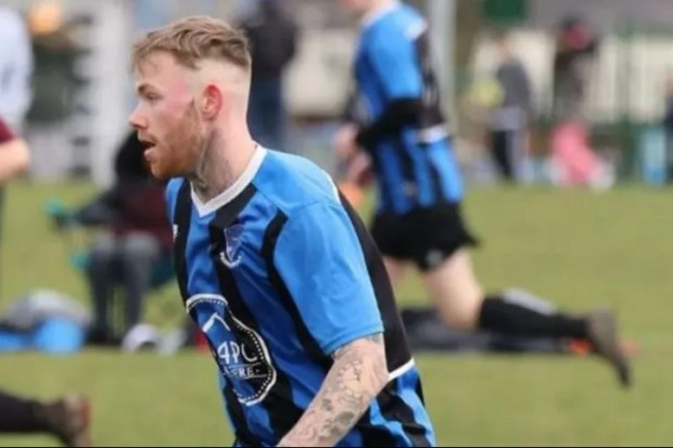 Soccer player in blue and black jersey.