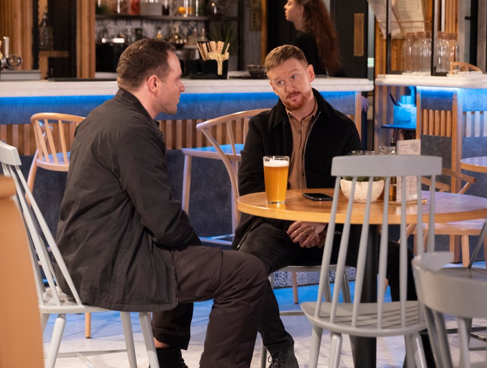 Two men having a drink and a conversation in a bistro.
